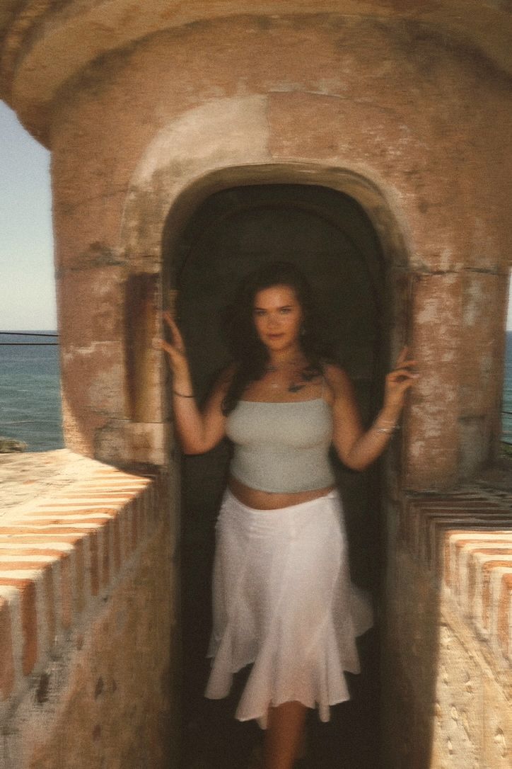 Hannah in the doorway of an old stone fort by the sea