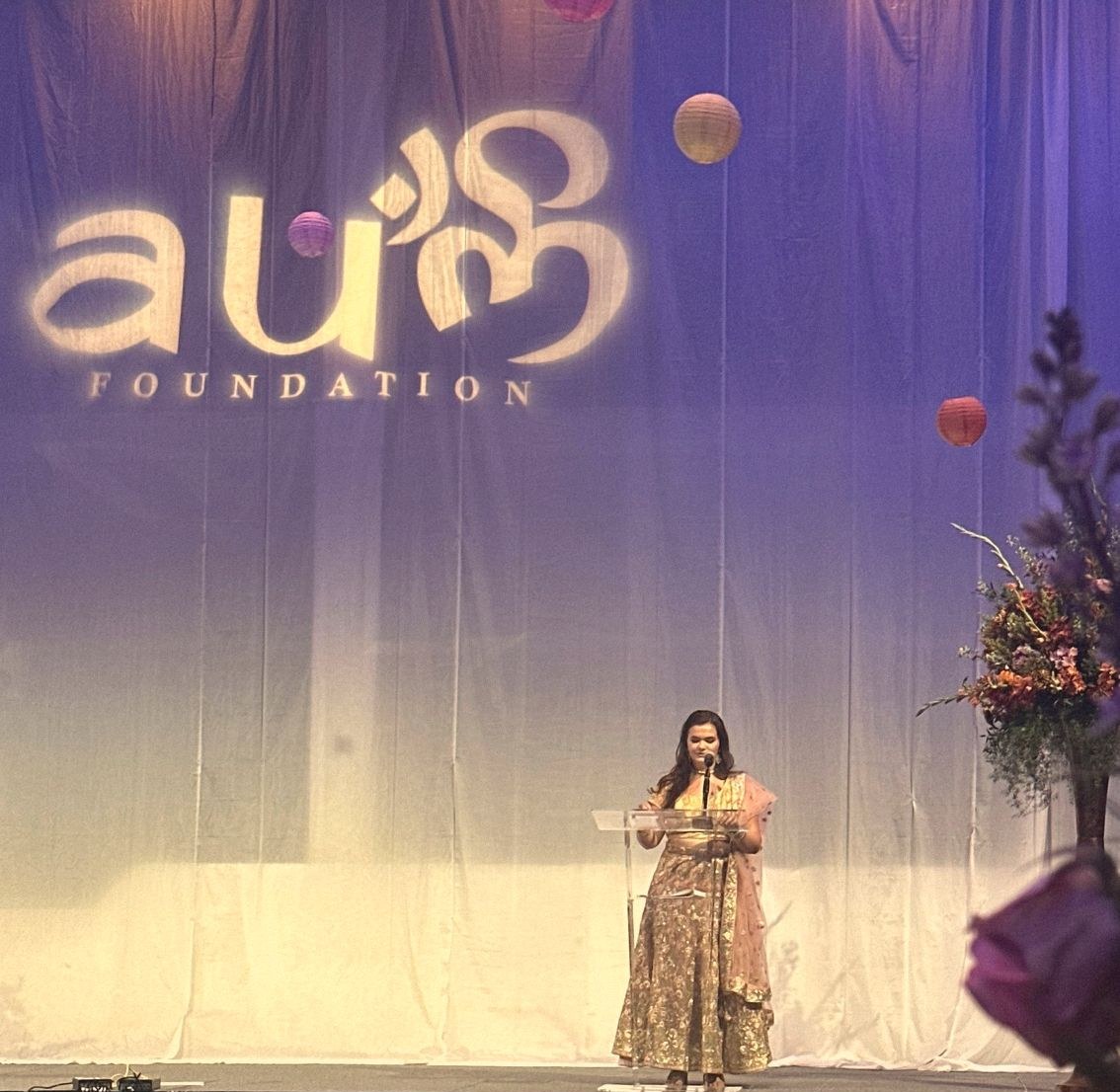 Hannah giving her keynote at the Aum Foundation