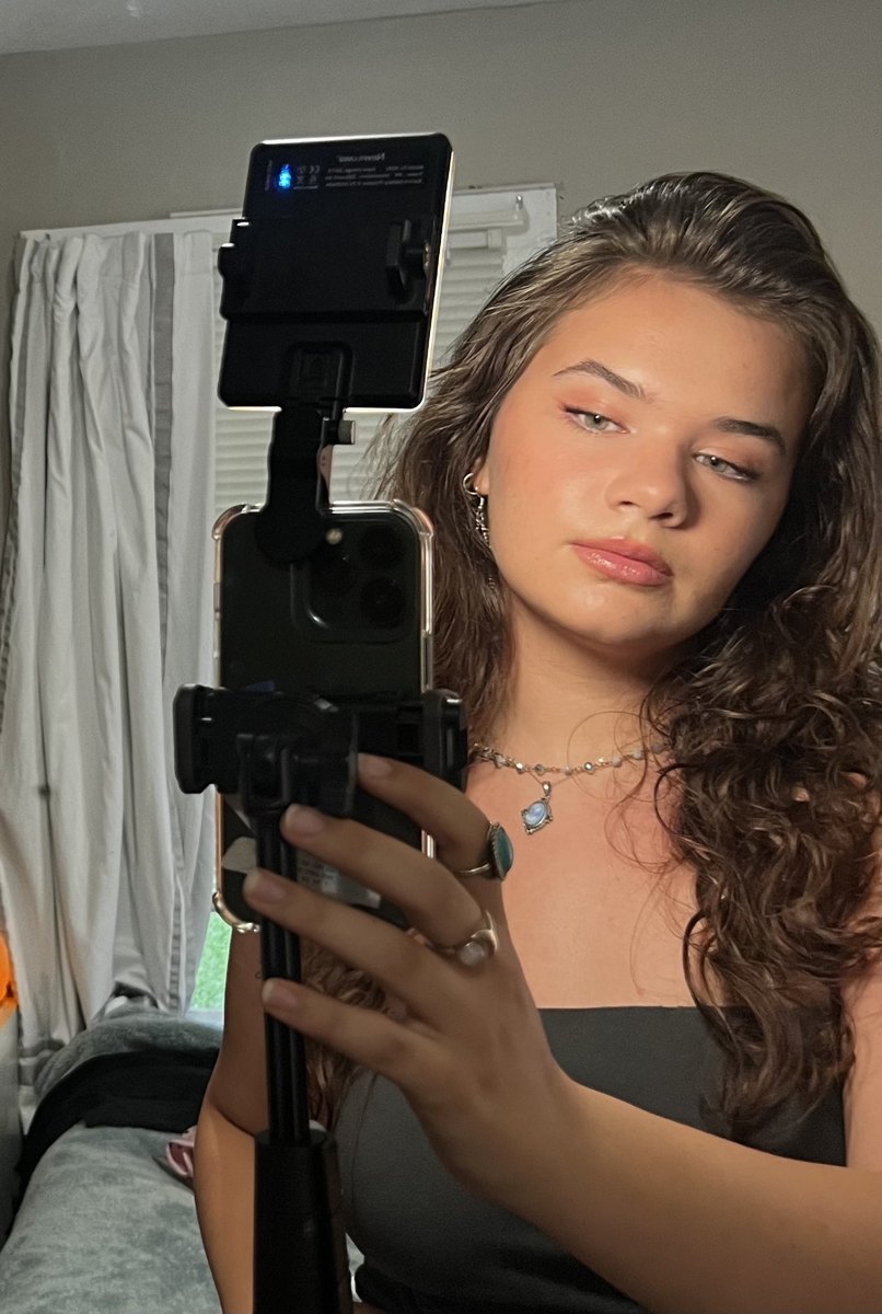 Hannah filming with her phone and light